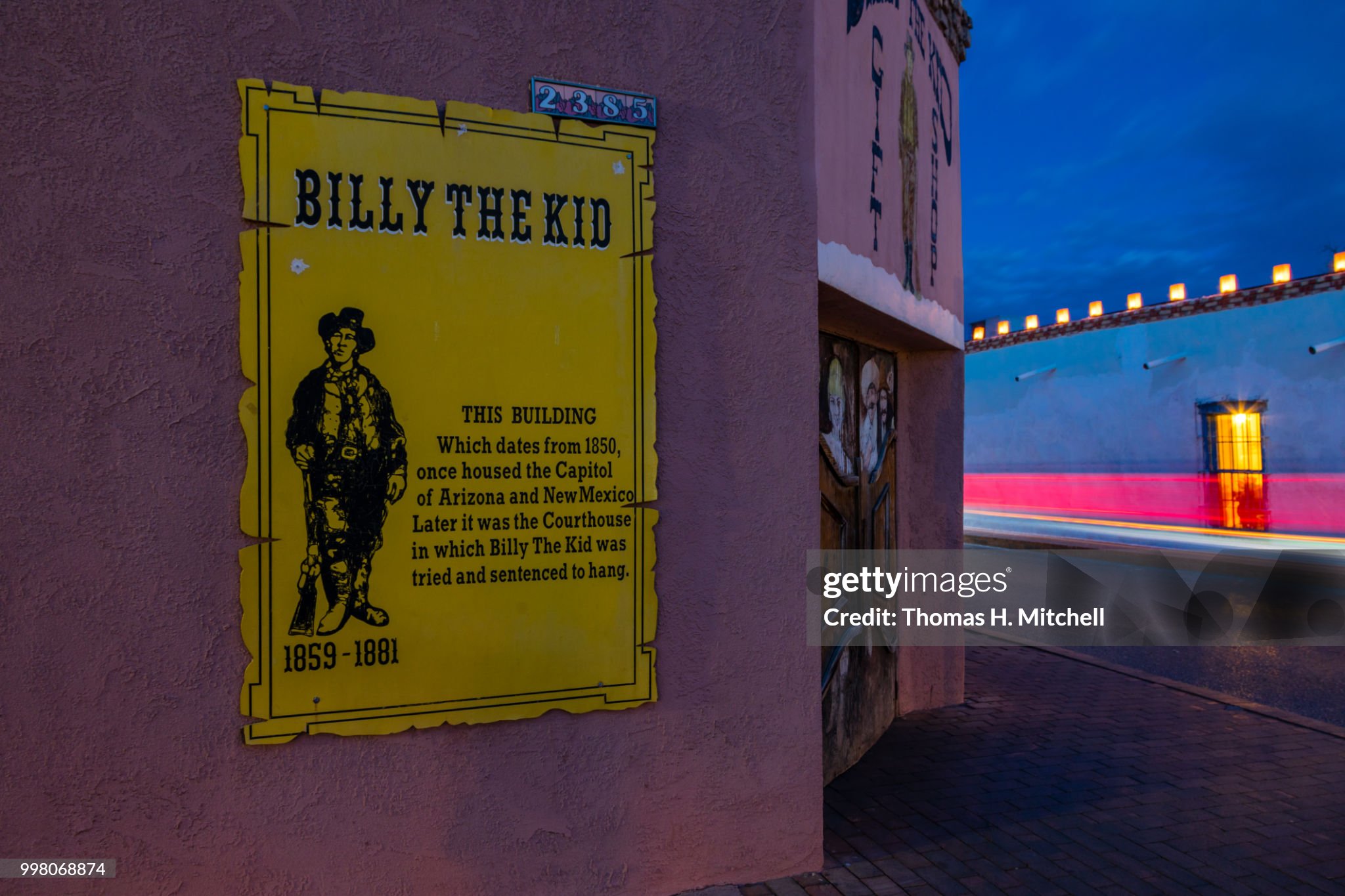 A historic building with an informative sign on Billy the Kid